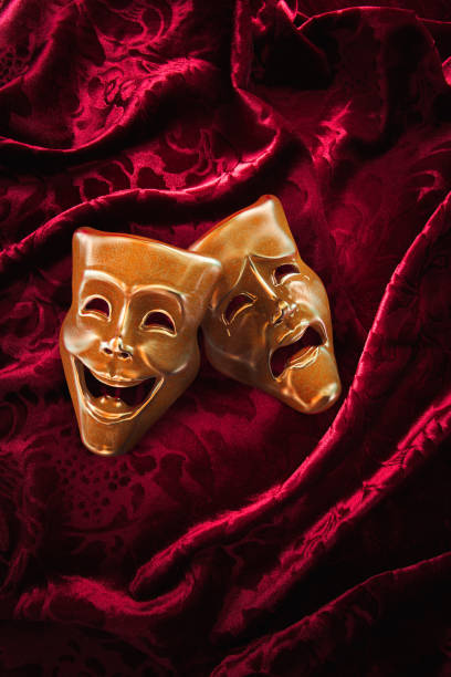 istock Theater masks over red curtain / 3D rendering 1003265592