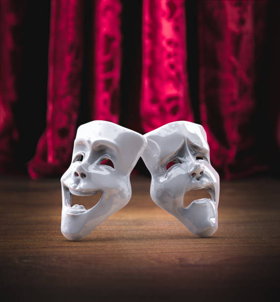 istock Theater masks in front of a red curtain/ 3D rendering 1003269048