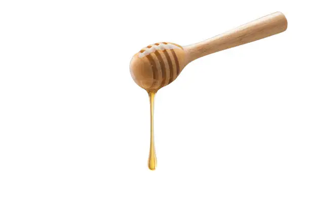 Organic Honey with wooden spoon on white background
