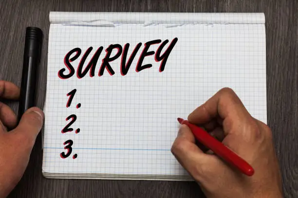Photo of Handwriting text writing Survey. Concept meaning Questioning group of people to gather opinion on a particular subject Graph paper thoughts ideas important marker pens practical book jobs.