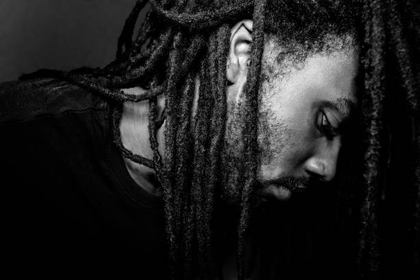 man down on his luck sad black man with dreadlocks looking down dreadlocks stock pictures, royalty-free photos & images