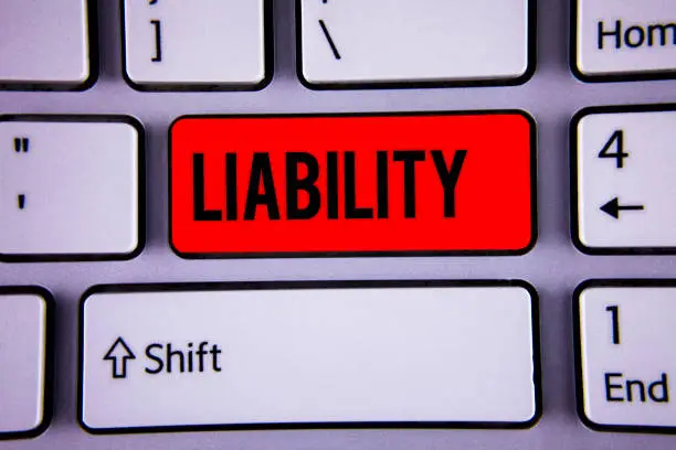 Conceptual hand writing showing Liability. Business photo text State of being legally responsible for something Responsibility Keyboard office typing work click assign button computer program