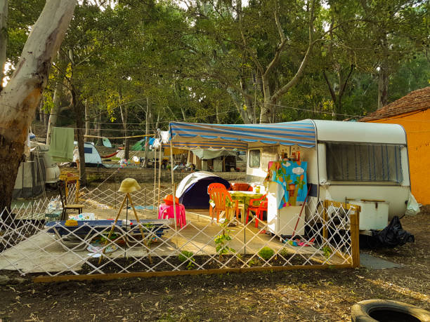 istock campinng tent forest caravan trailer  summer season 1003283872