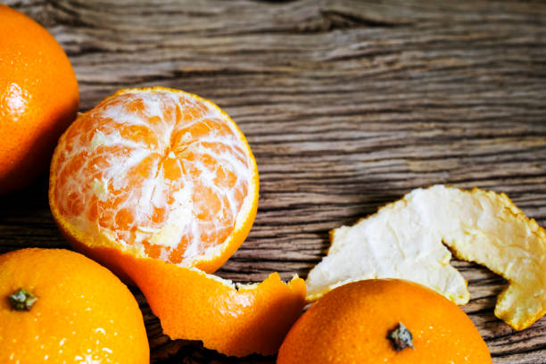 istock Mandarin oranges on wood background with copy space 1003291438