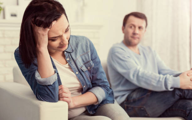 istock Cheerless unhappy woman holding her forehead 1003296078