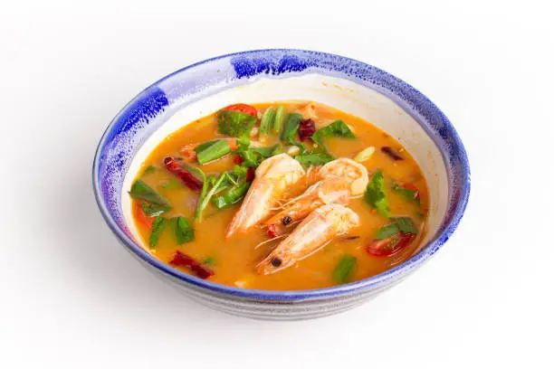 Photo of Traditional thai cuisine, Tom yum goong, Spicy shrimp soup on white background