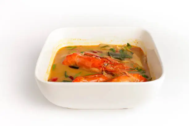 Photo of Traditional thai cuisine, Tom yum goong, Spicy shrimp soup on white background