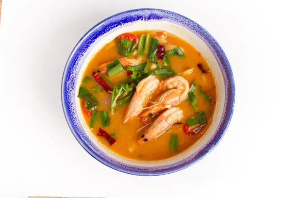 Photo of Traditional thai cuisine, Tom yum goong, Spicy shrimp soup on white background