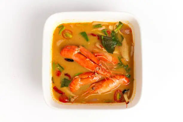 Photo of Traditional thai cuisine, Tom yum goong, Spicy shrimp soup on white background