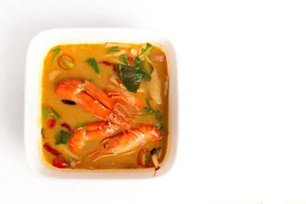 Photo of Traditional thai cuisine, Tom yum goong, Spicy shrimp soup on white background