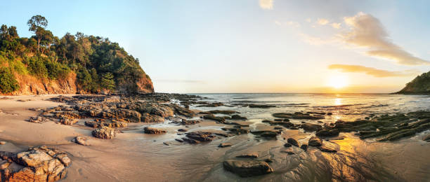 istock High resolution wide panorama of sunset on Koh Lanta beach during low tide. 1003303898