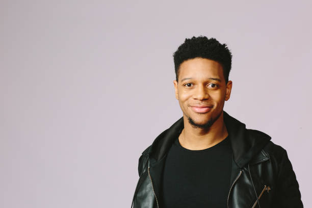 istock Happy young man smiling and looking at camera 1003312402