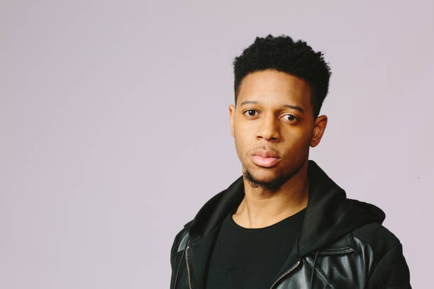 istock Simple horizontal portrait of a serious young man in black looking at camera 1003312408