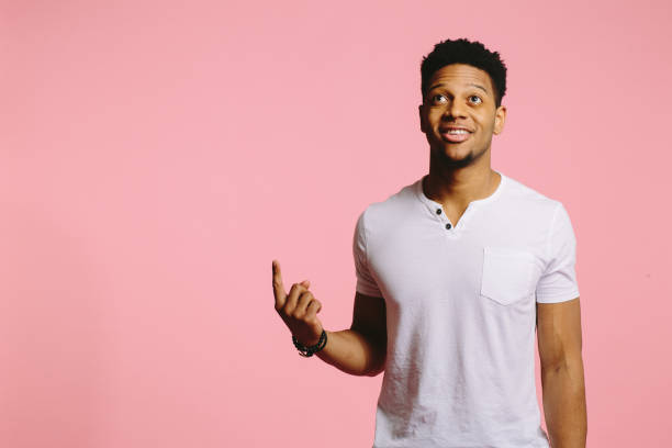 istock Portrait of an attractive cool guy pointing and looking up 1003312458