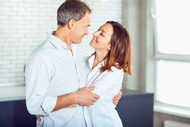 istock Mature couple happy hugging indoors 1003319214
