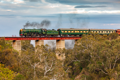 Currency Creek, Australia, July 15, 2018: Preserved SAR steam locomotive 621 crosses the iconic Currency Creek bridge with the Steamranger Southern Encounter tourist train as it returns from an excursion tour to Goolwa and Victor Harbor.