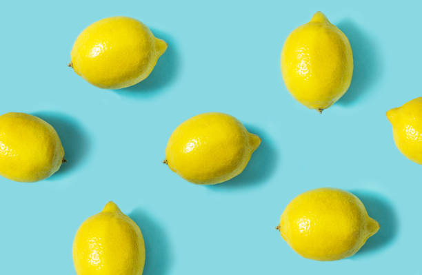 istock Top view of fresh lemon isolated on blue background. Fruit minimal concept. 1003329442