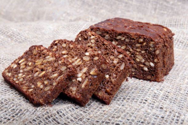 istock Fresh homemade bread on Sackcloth woven texture background. Selective focus. 1003332022