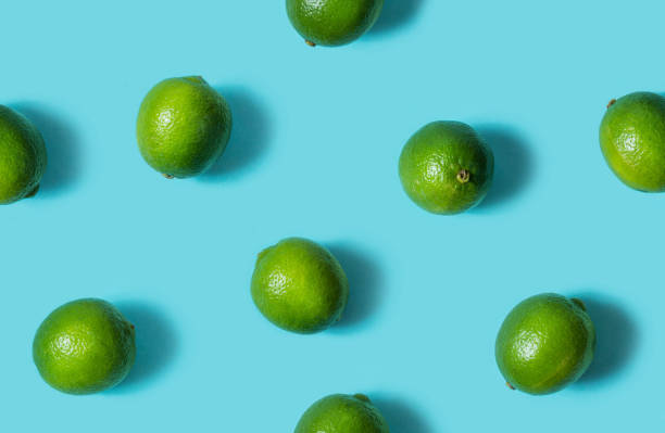 istock Top view of fresh lime isolated on blue background 1003332232