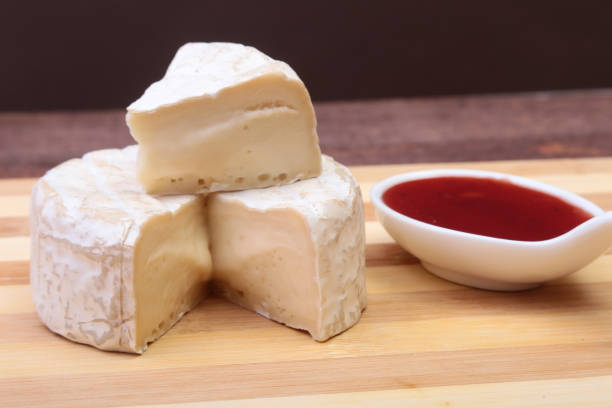 istock Cheese with white mold. Camembert or brie type with Cranberry sauce.. Healthy breakfast. 1003335840