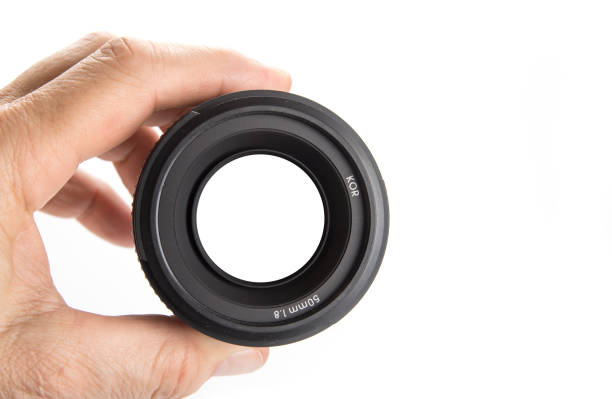 istock Hand holding camera lens on the white with the sign focus on 1003336522
