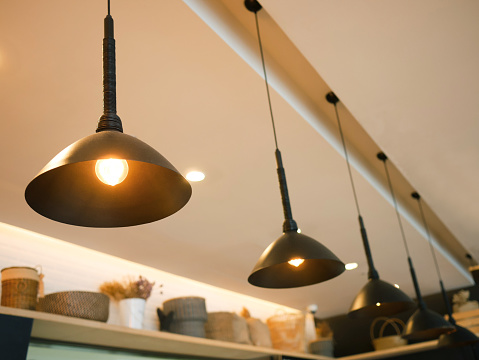 Vintage industrial lamps hanging from the ceiling in a cafe