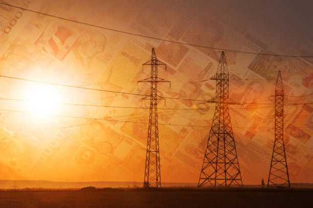 istock High-voltage power transmission line. Energy pillars. At sunset, different currency 1003356964