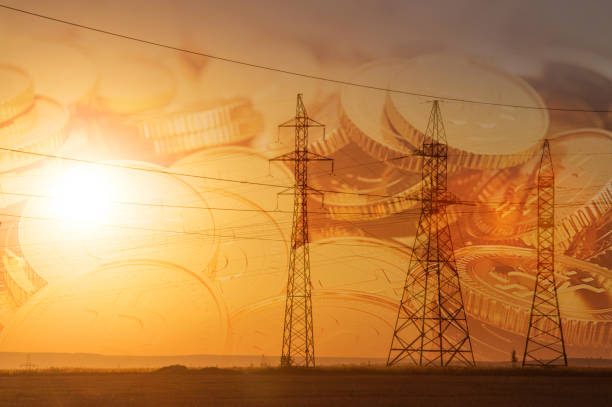 istock High-voltage power transmission line. Energy pillars. At sunset, 1003357136