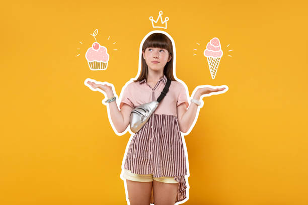 istock Cute girl putting her hands up and choosing sweets 1003357770