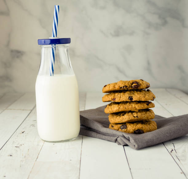Milk and cookies on wood background