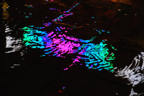 istock A puddle on a rainy night in the city with reflections of lanterns. 1003368040