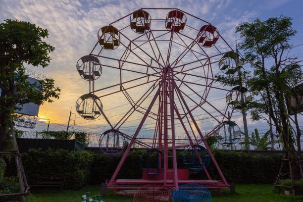 istock Ferris wheel without people over cloudy sky 1003373114