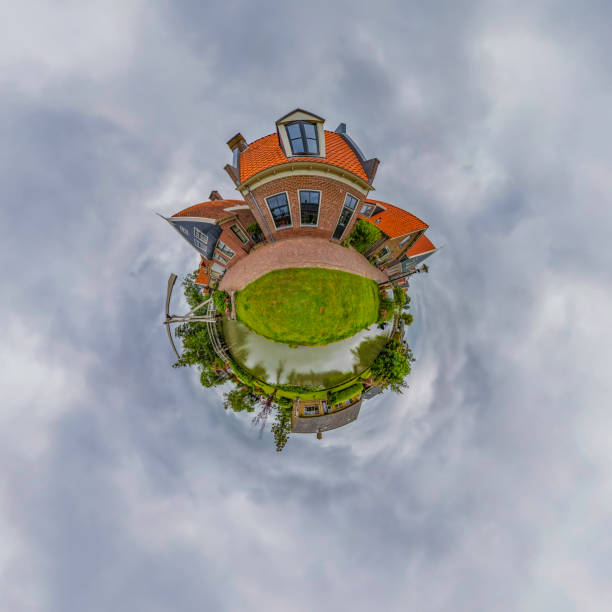 360 degrees spherical panoramic shot of a traditional Dutch village with old houses, wooden bridge and canal