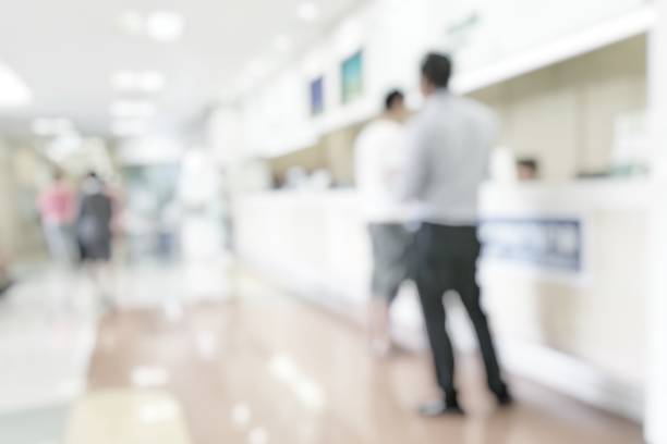 istock Medical blur background customer reception or patient service counter, office lobby in hospital clinic, or bank business building blurry interior inside waiting hall area 1003386138