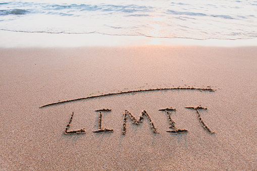 limit concept, line and word on the sand