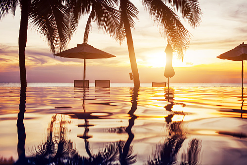 beach hotel swimming pool at sunset
