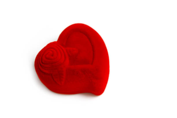 istock A red jewelry box in a shape of heart, isolated on white background. Expensive gift concept, marriage preposition. 1003395708