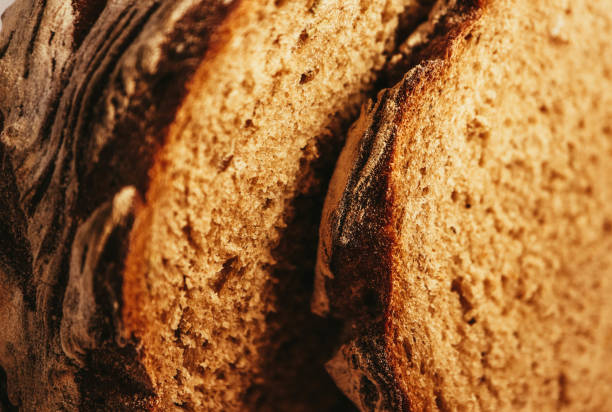istock A piece of handmade freshly baked rye bread, texture background, closeup. 1003398574