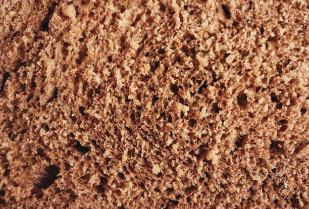 istock A piece of handmade freshly baked rye bread, texture background, closeup. 1003398666