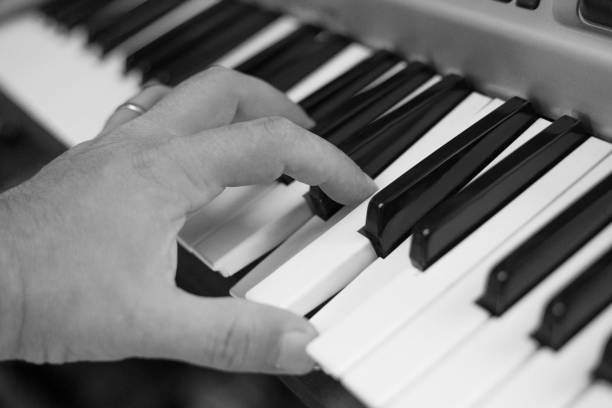 istock Cropped Hand Of Man Playing Piano 1003399270