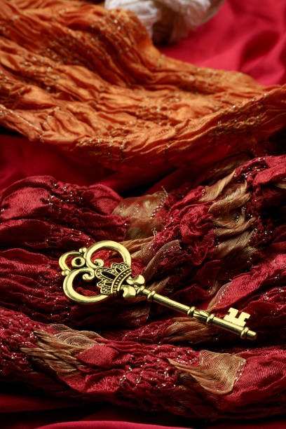 istock Antique Golden Key on Red Fabric 1003399368
