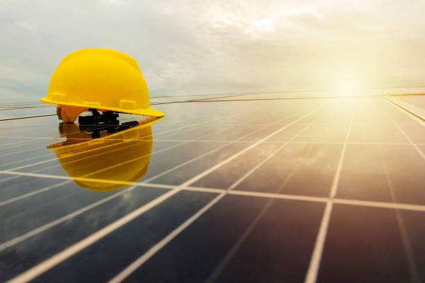 istock Engineer helmet put on photovoltaic.Rainy in the sunset. 1003412404