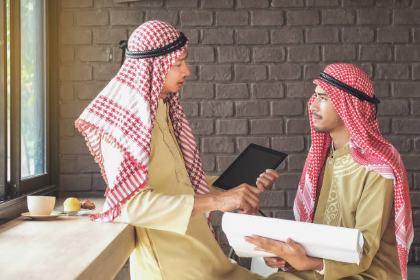 istock Side View Of Businessmen Discussing In Office 1003412960