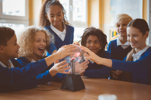 istock School kids touching plasma ball during phisics lesson at school 1003416478