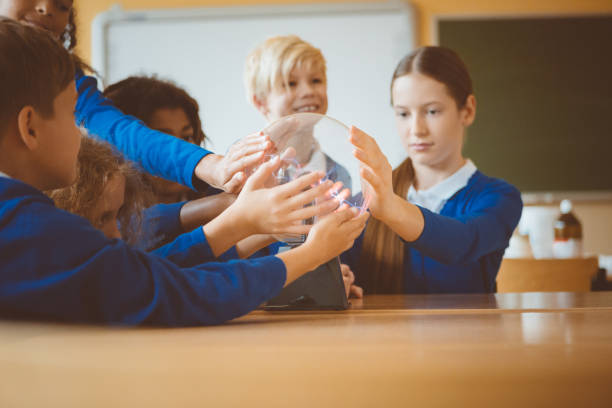 istock School kids touching plasma ball during physics lesson at school 1003416730
