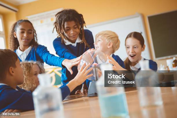 School Kids Touching Plasma Ball During Physics Lesson At School Stock Photo - Download Image Now