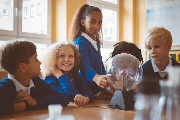 istock School kids touching plasma ball during physics lesson at school 1003417010