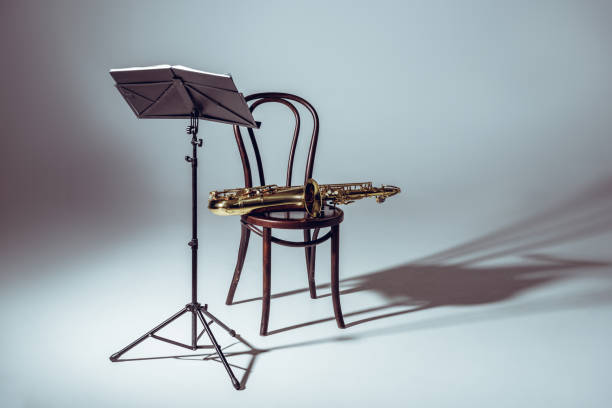 music stand for notes and saxophone on chair in studio