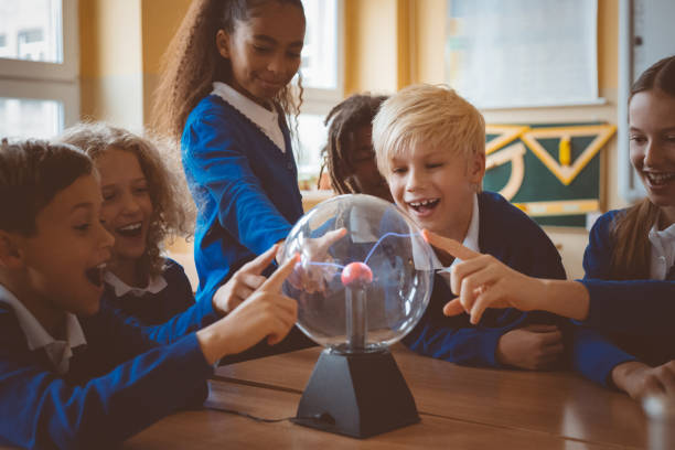 istock School kids touching plasma ball during physics lesson at school 1003417410