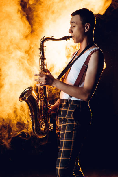 istock side view of expressive professional saxophonist playing sax in smoke 1003417478